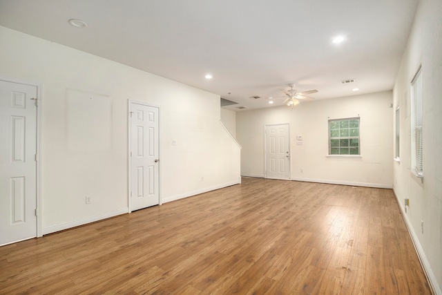 empty room featuring light wood-type flooring and ceiling fan