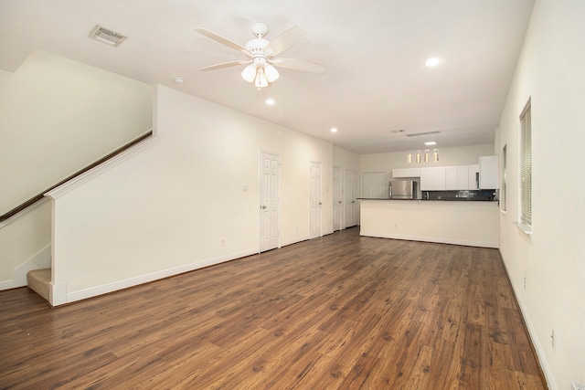 unfurnished living room featuring dark hardwood / wood-style flooring and ceiling fan