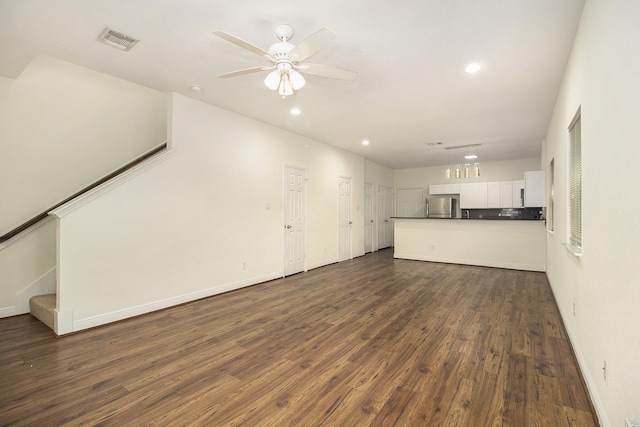 unfurnished living room with a ceiling fan, visible vents, baseboards, dark wood-style floors, and recessed lighting
