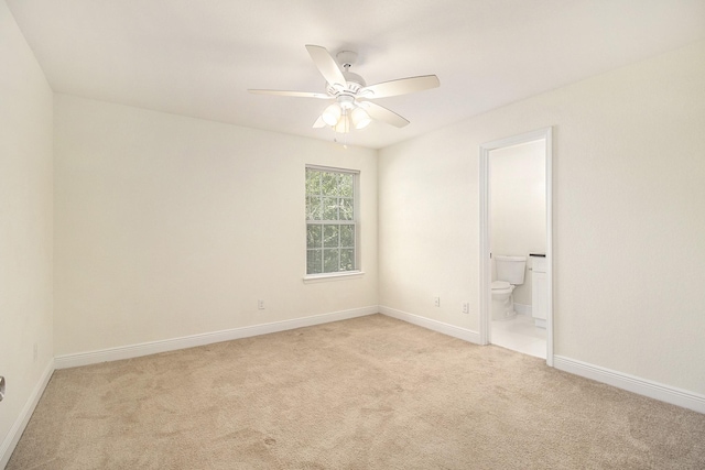 unfurnished bedroom with baseboards, ceiling fan, light carpet, and connected bathroom