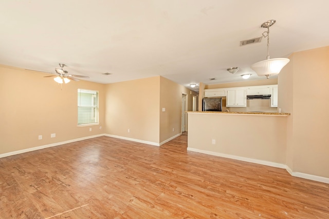 unfurnished living room with light wood-type flooring and ceiling fan