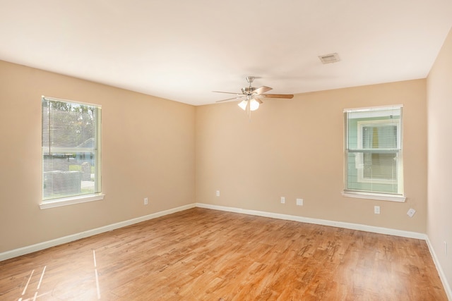 empty room with light hardwood / wood-style floors and ceiling fan