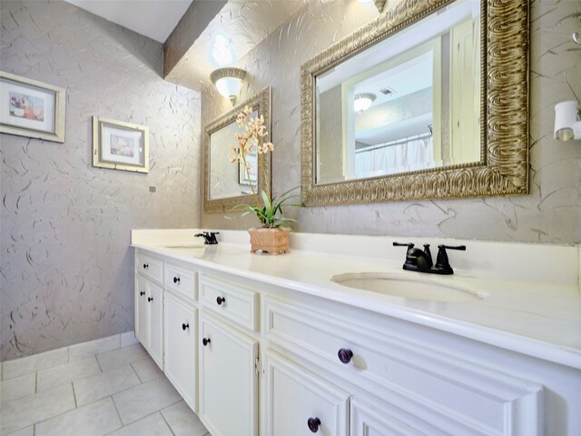 bathroom with tile patterned floors and vanity