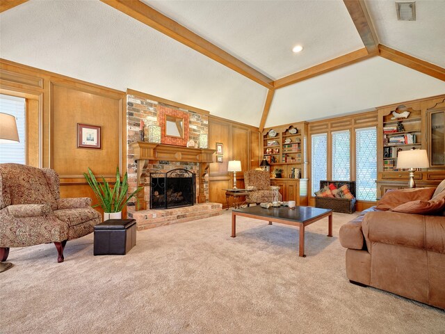 living room featuring lofted ceiling with beams, a healthy amount of sunlight, light colored carpet, and wooden walls