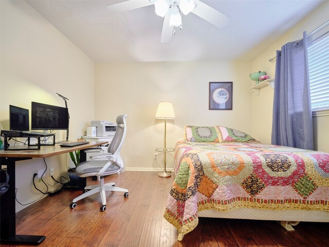 bedroom with ceiling fan and wood-type flooring