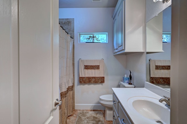 bathroom with a shower with curtain, vanity, toilet, and tile patterned floors