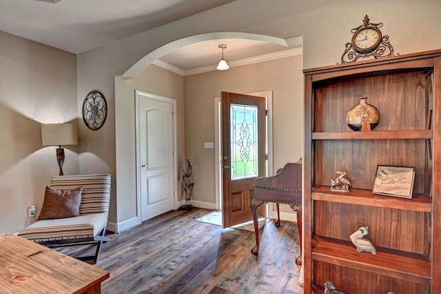 foyer entrance featuring ornamental molding and hardwood / wood-style floors