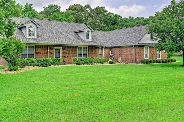 cape cod home with a front yard