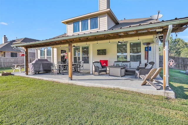 back of property featuring a patio area, a lawn, an outdoor living space, and ceiling fan