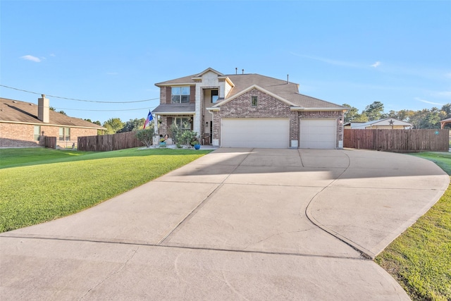 view of front facade featuring brick siding, concrete driveway, a front yard, and fence