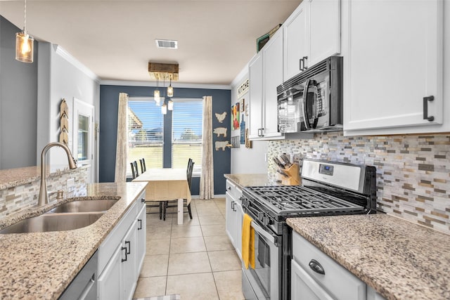 kitchen featuring visible vents, ornamental molding, a sink, black microwave, and gas range