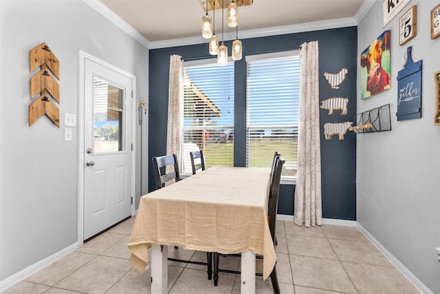 dining area with light tile patterned floors, baseboards, and ornamental molding