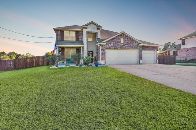 view of front of home featuring a garage and a yard