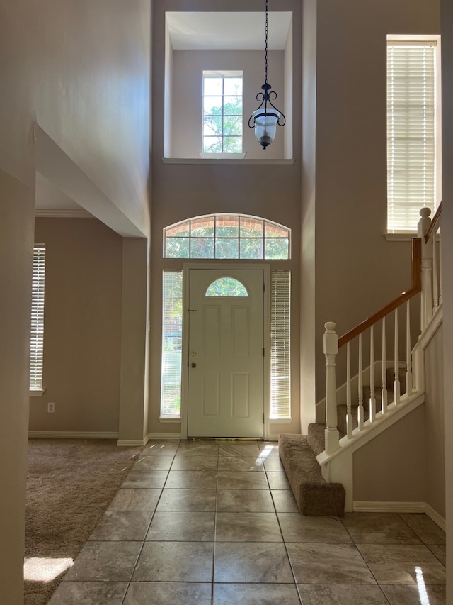 entrance foyer with an inviting chandelier and a towering ceiling