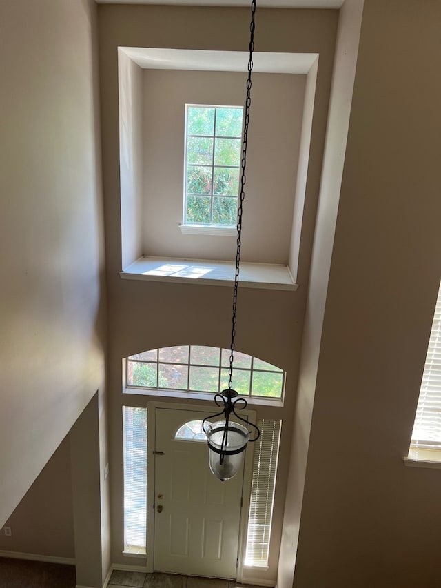 entryway featuring a notable chandelier and plenty of natural light