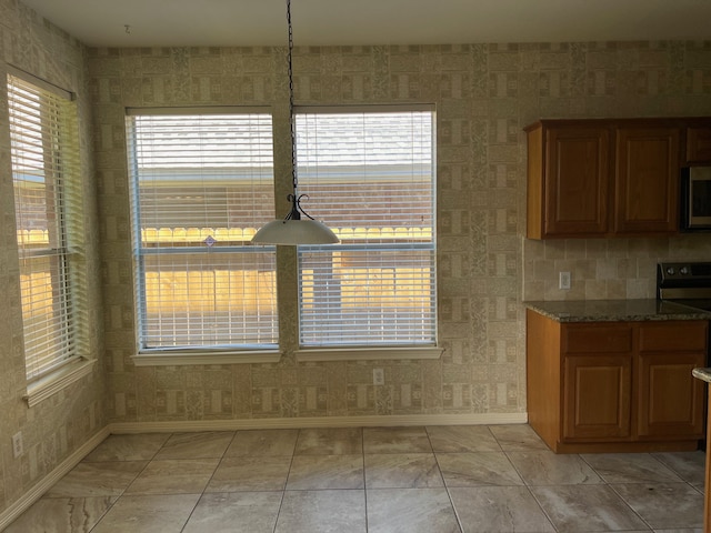 unfurnished dining area featuring a wealth of natural light