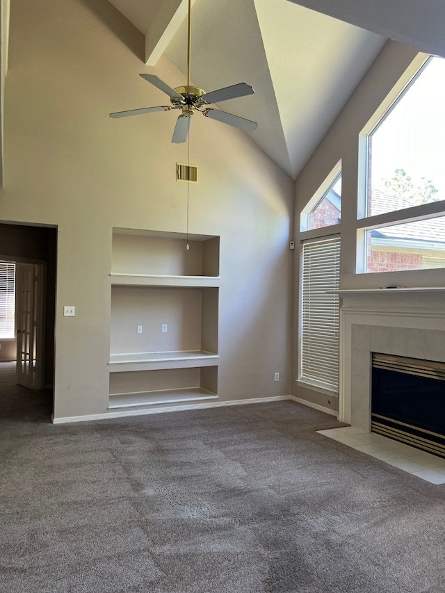 unfurnished living room featuring ceiling fan, a fireplace, carpet, and high vaulted ceiling