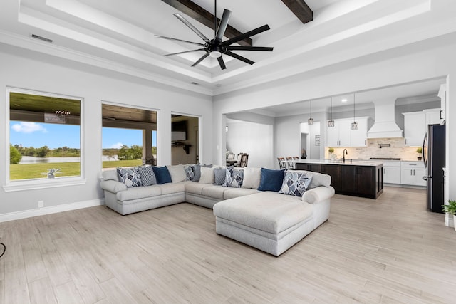 living room with ceiling fan, light hardwood / wood-style flooring, crown molding, and sink