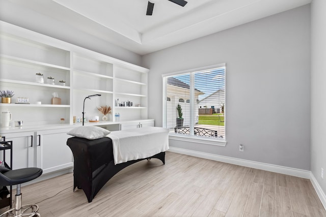 home office with ceiling fan and light hardwood / wood-style flooring