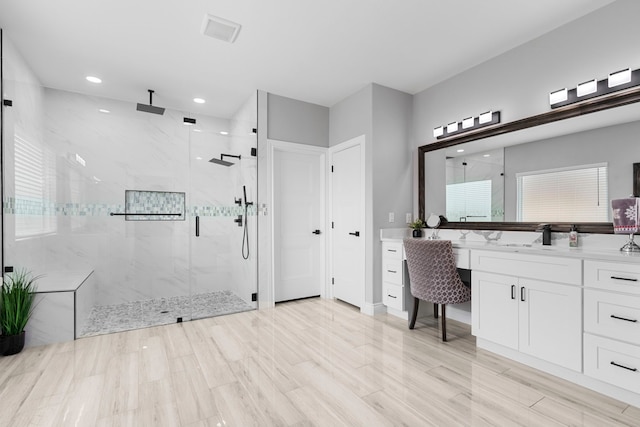 bathroom featuring vanity, hardwood / wood-style floors, and an enclosed shower