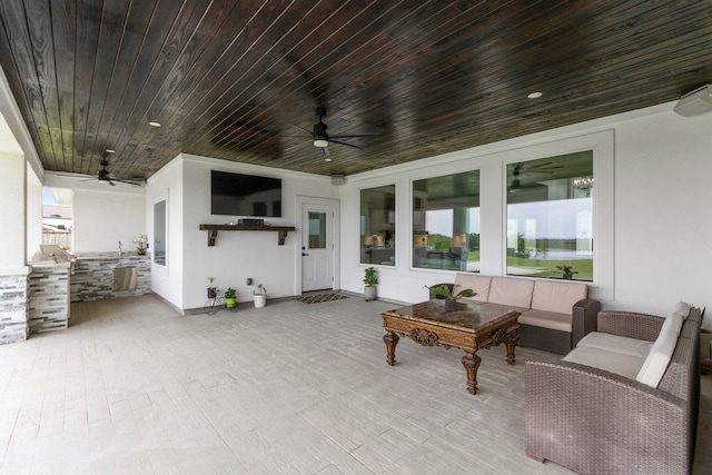 view of patio / terrace featuring an outdoor living space, ceiling fan, french doors, and an outdoor kitchen