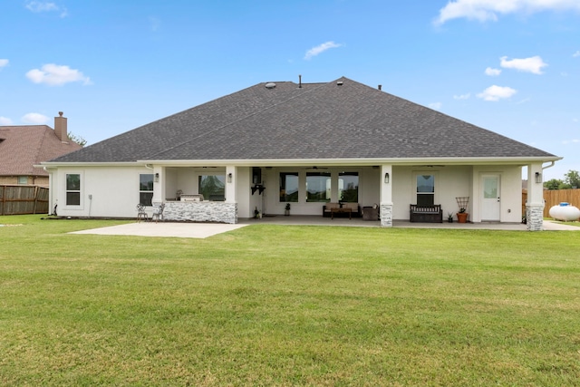 back of property featuring a yard and a patio