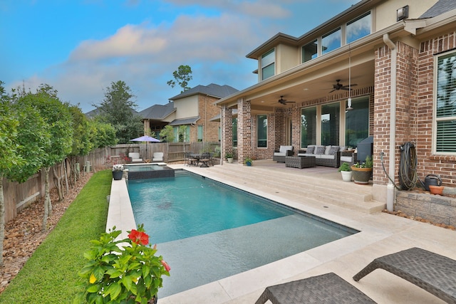 view of swimming pool featuring outdoor lounge area, ceiling fan, a patio area, and an in ground hot tub