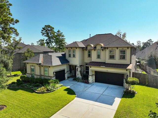 french country style house featuring a garage and a front lawn