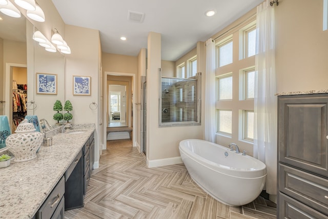 bathroom featuring shower with separate bathtub, vanity, and plenty of natural light