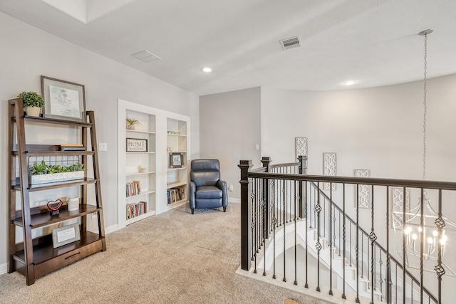 sitting room with carpet and built in shelves