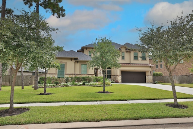 view of front of home with a garage and a front lawn