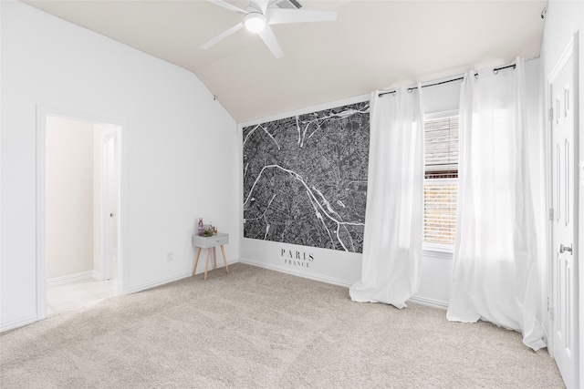 unfurnished room featuring ceiling fan, light carpet, and lofted ceiling