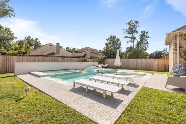 view of swimming pool featuring an in ground hot tub, a yard, and a patio area