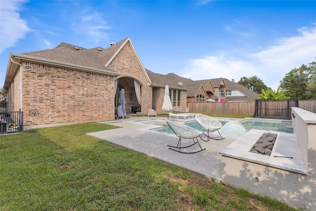 view of swimming pool featuring a yard and a patio