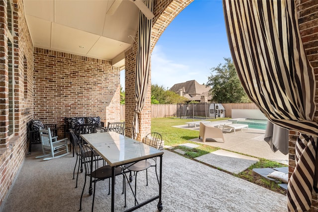 view of patio / terrace with a fenced in pool