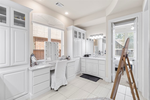 bathroom featuring vanity, tile patterned flooring, and ceiling fan