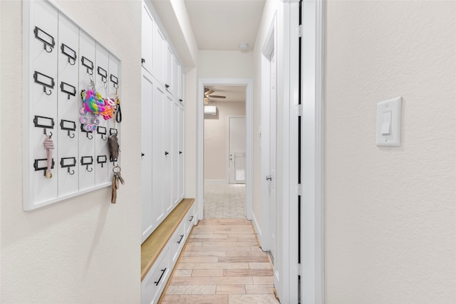 hallway with light hardwood / wood-style floors