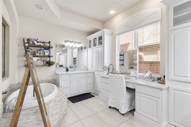 bathroom featuring vanity, tiled bath, and tile patterned flooring