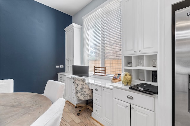 office area with light hardwood / wood-style floors