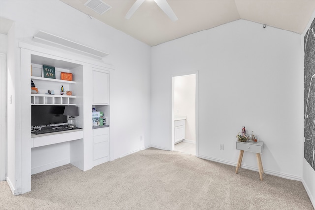 living room featuring built in desk, lofted ceiling, light carpet, and ceiling fan