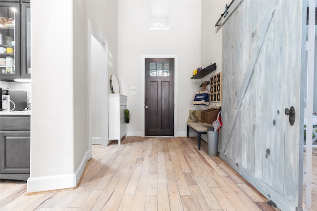 entrance foyer featuring light hardwood / wood-style flooring and a barn door