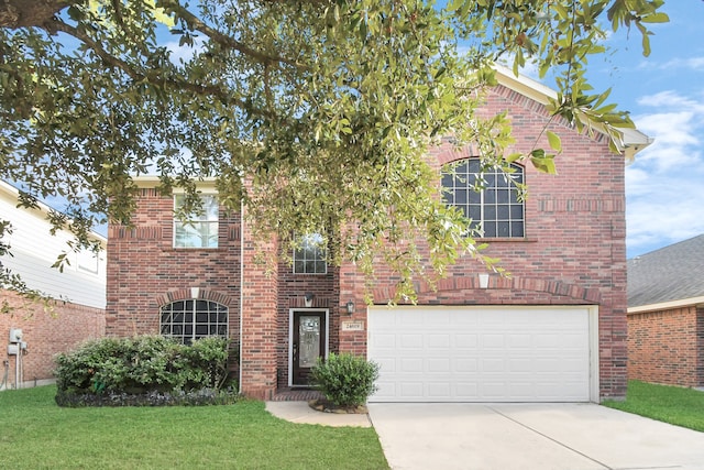 front facade featuring a front yard and a garage