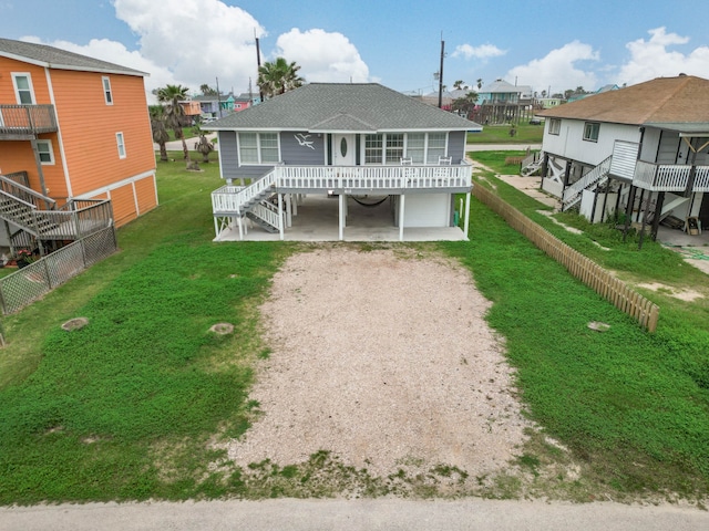 rear view of property featuring a lawn