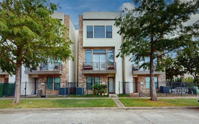 view of front facade featuring cooling unit and a balcony