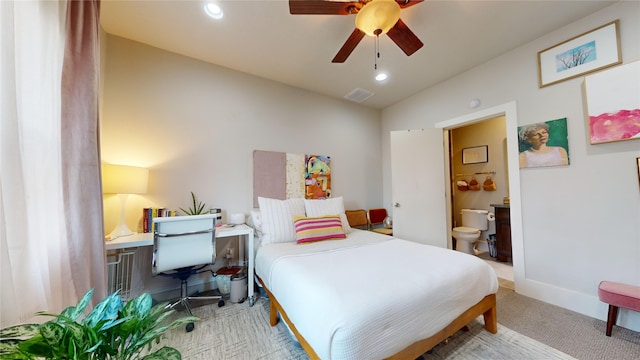 bedroom with connected bathroom, lofted ceiling, ceiling fan, and light colored carpet