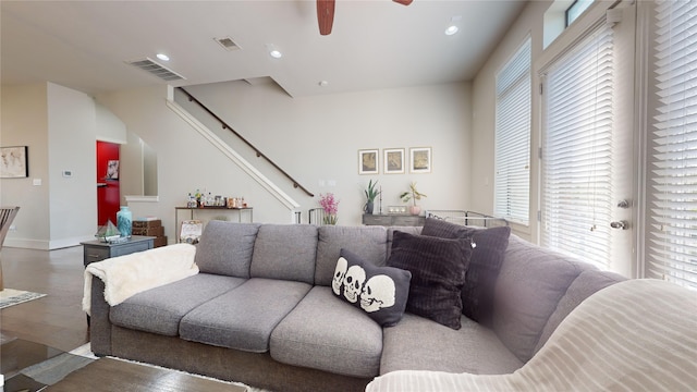 living room with ceiling fan and dark wood-type flooring