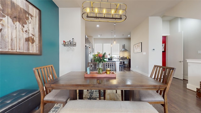 dining space featuring an inviting chandelier and dark hardwood / wood-style flooring