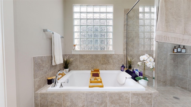 bathroom featuring separate shower and tub and a wealth of natural light