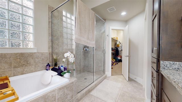 bathroom featuring vanity, separate shower and tub, plenty of natural light, and tile patterned floors