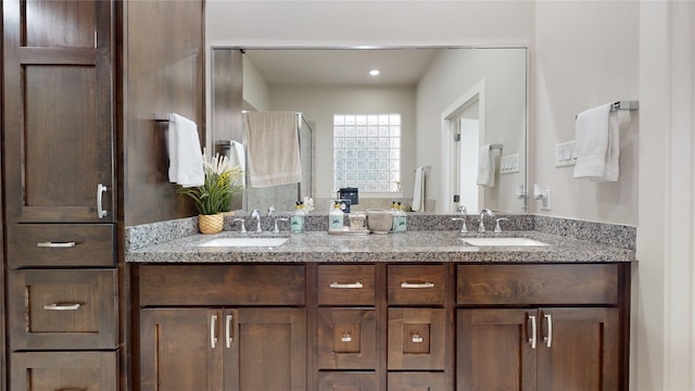 bathroom with a shower with door and vanity